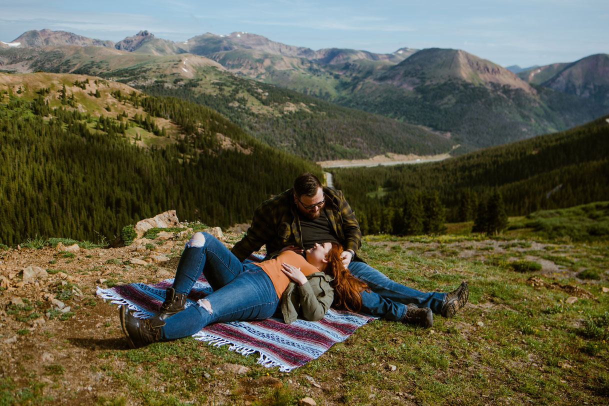 Couple sitting on a blanket in front of mountains in Breckenridge, Colorado