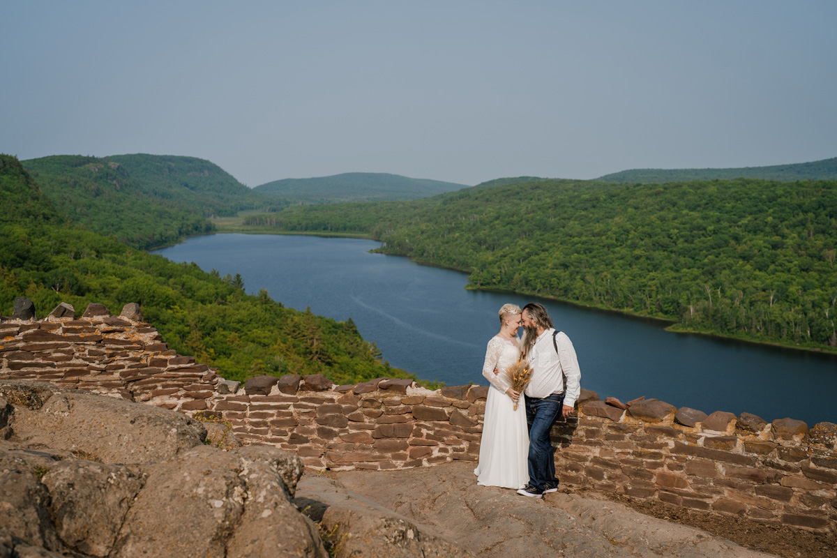 Elopement couple posing together at the Lake of the Clouds overlook in the Porcupine Mountains
