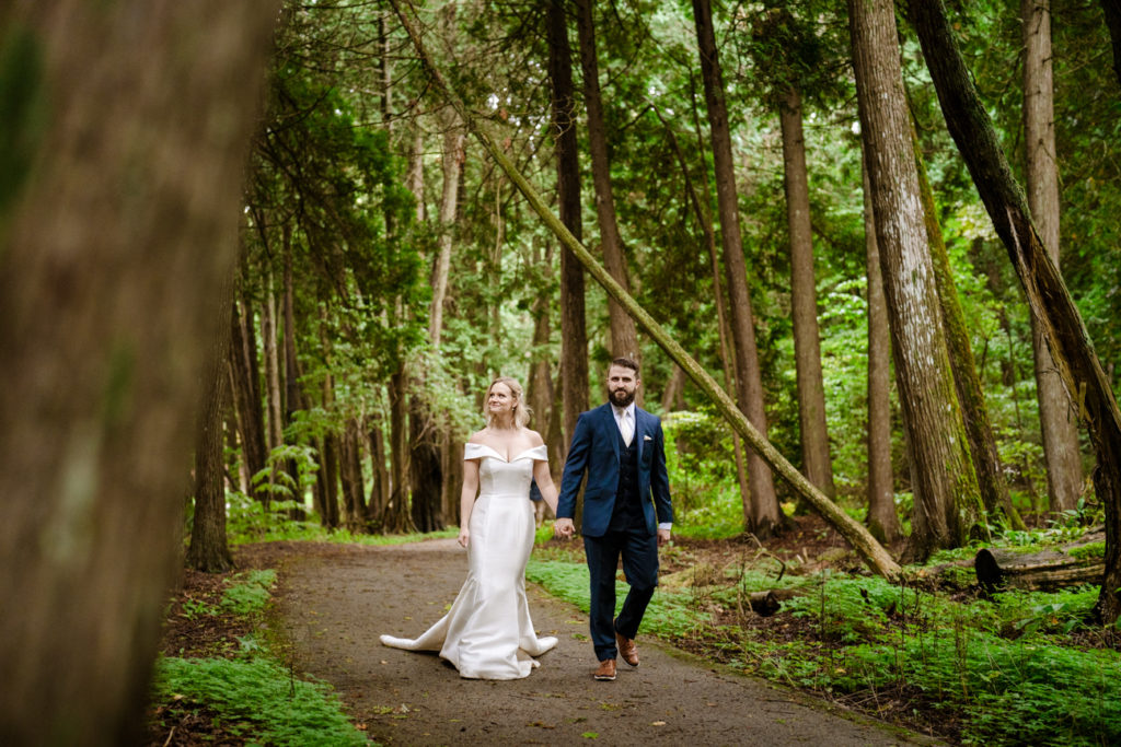 Elopement couple hiking in the woods on Mackinac Island