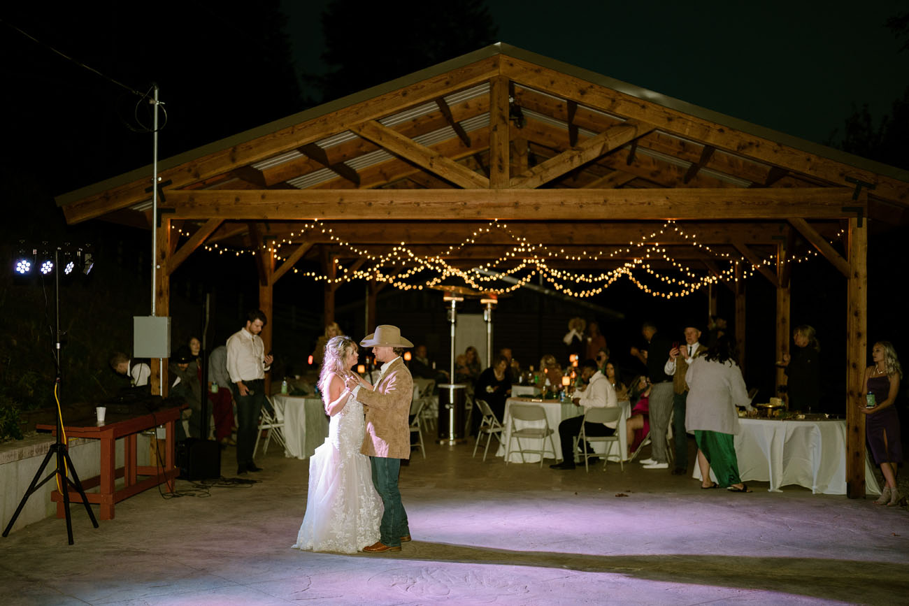 Couple dancing by a pavilion at their Montana destination wedding
